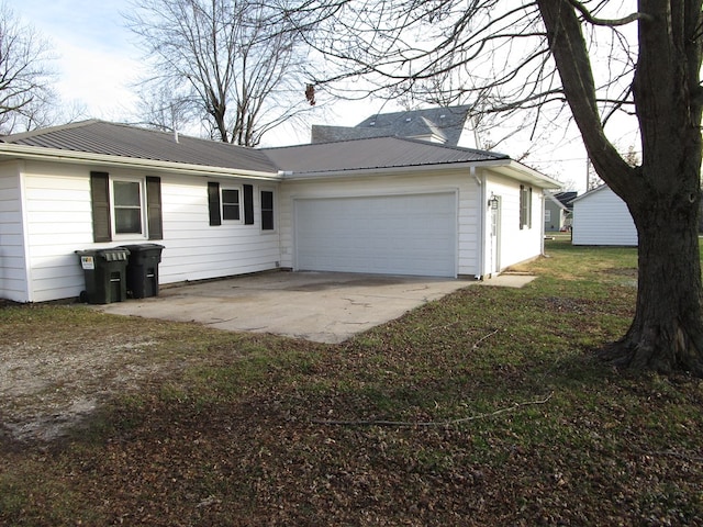 exterior space featuring a front lawn and a garage