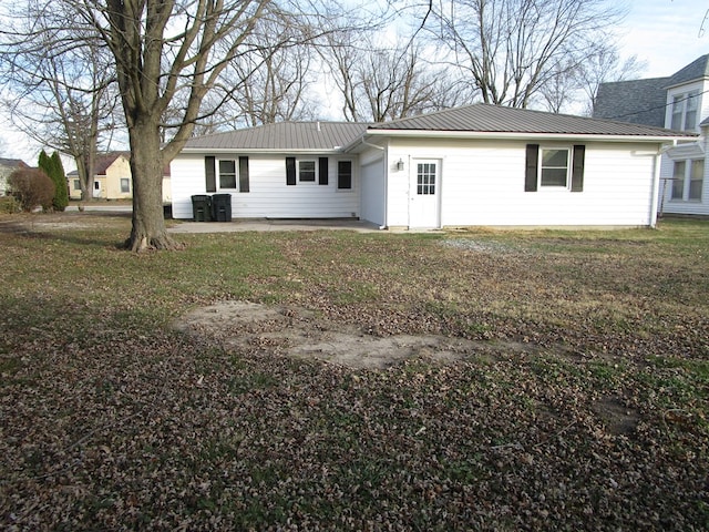 back of property with a lawn