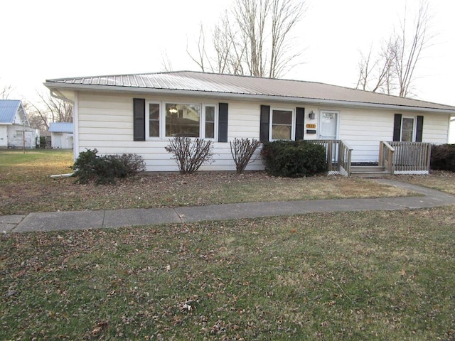 single story home featuring a front lawn