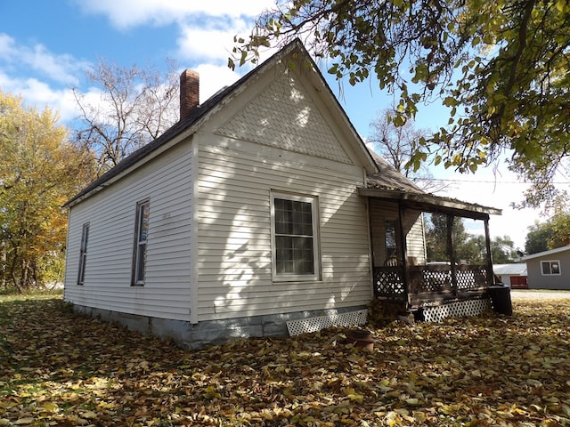 view of side of property with a porch