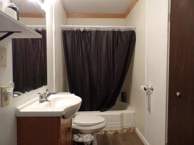 full bathroom featuring shower / tub combo, vanity, crown molding, hardwood / wood-style floors, and toilet