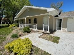 bungalow featuring a porch and a garage