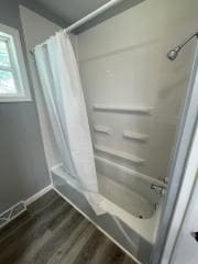 bathroom with wood finished floors and baseboards