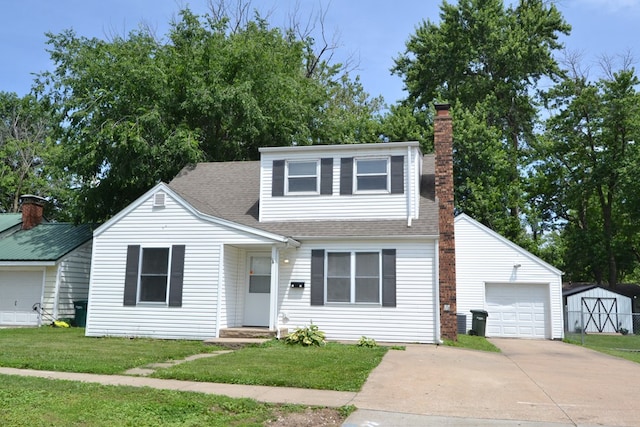 1415 E Patterson St, Kirksville, MO 63501 - view of front of house featuring a chimney, driveway, a front lawn, a shingled roof, and a garage