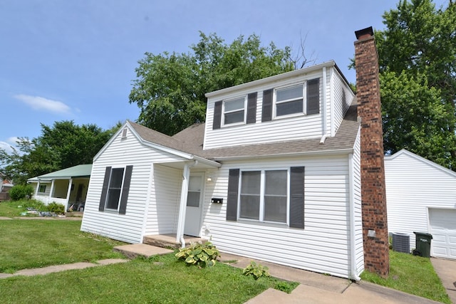 1415 E Patterson St, Kirksville, MO 63501 - view of front of property with a chimney, a front yard, roof with shingles, an outbuilding, and a garage