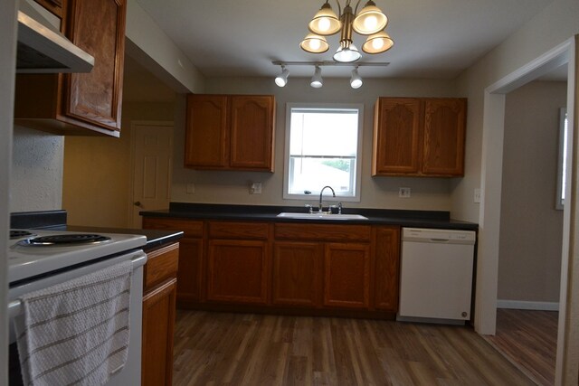 1415 E Patterson St, Kirksville, MO 63501 - kitchen featuring white appliances, ventilation hood, wood finished floors, a chandelier, and dark countertops