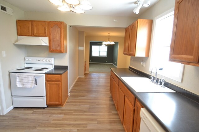 1415 E Patterson St, Kirksville, MO 63501 - kitchen featuring a chandelier, white appliances, under cabinet range hood, dark countertops, and light wood-style flooring