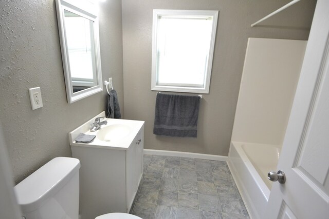 1415 E Patterson St, Kirksville, MO 63501 - bathroom featuring vanity, a bath, stone finish floors, and a shower