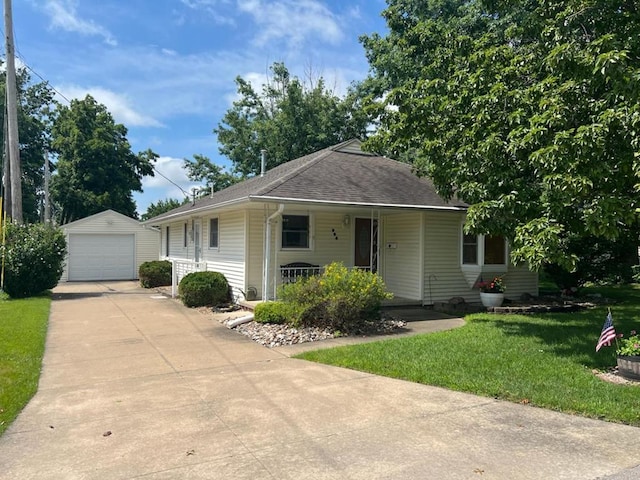 904 E George St, Kirksville, MO 63501 - view of front of house featuring an outdoor structure, driveway, a detached garage, a front lawn, and a porch