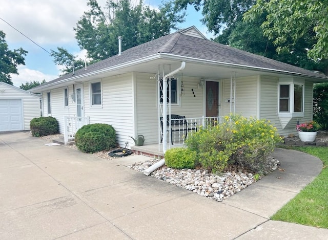 904 E George St, Kirksville, MO 63501 - view of front facade with a porch, roof with shingles, and an outdoor structure