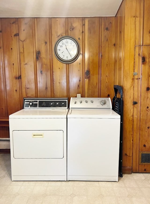 904 E George St, Kirksville, MO 63501 - washroom featuring separate washer and dryer, wooden walls, light flooring, and a baseboard radiator