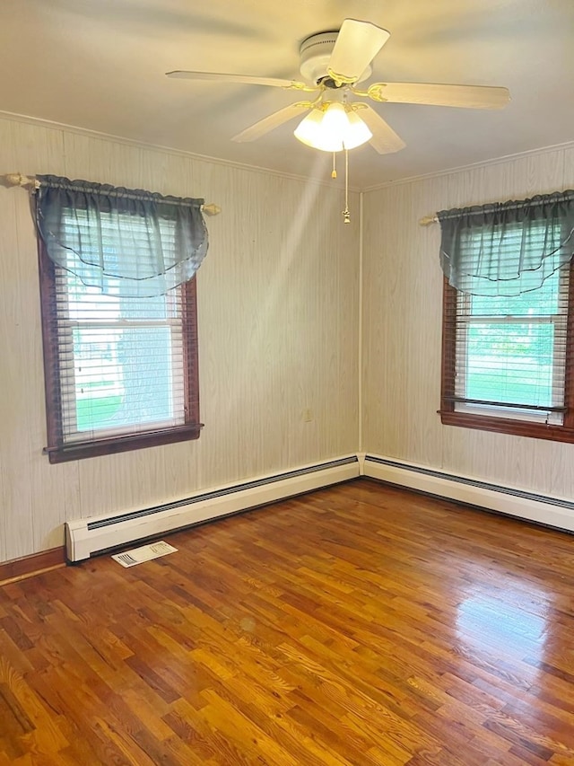 904 E George St, Kirksville, MO 63501 - empty room with wood finished floors, ceiling fan, crown molding, and baseboard heating