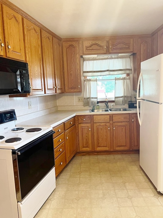 904 E George St, Kirksville, MO 63501 - kitchen featuring white appliances, brown cabinetry, light floors, and light countertops