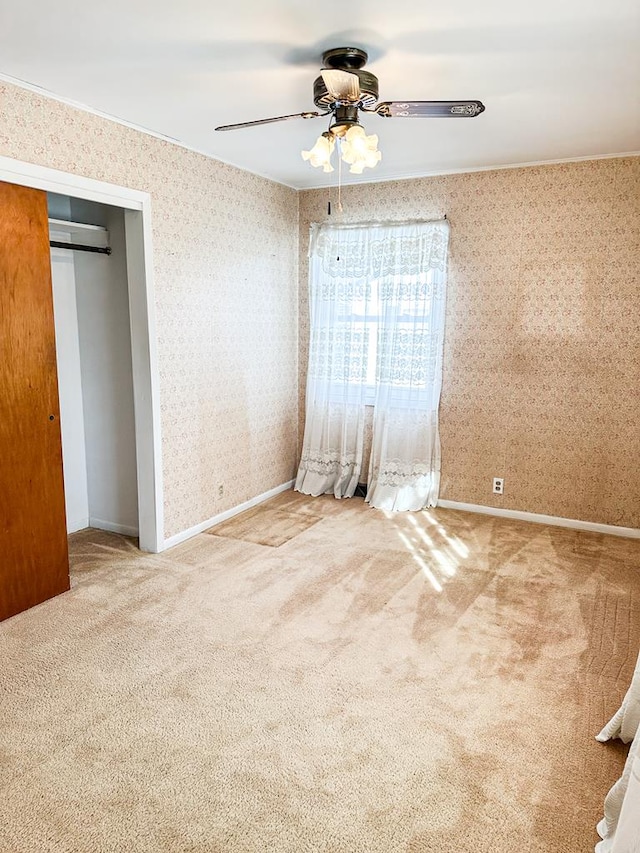 unfurnished bedroom with a closet, ceiling fan, and carpet flooring