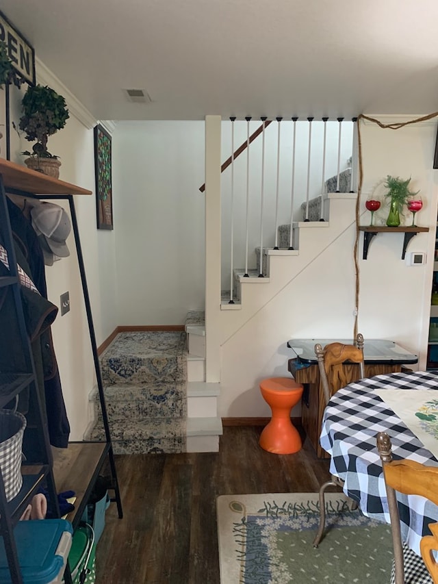 stairway with wood finished floors and visible vents