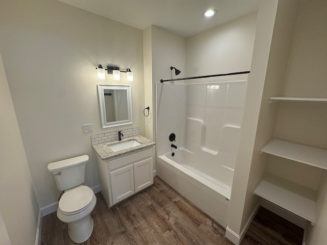 22585 State Highway K, Novinger, MO 63559 - bathroom featuring wood finished floors, vanity, bathtub / shower combination, recessed lighting, and decorative backsplash