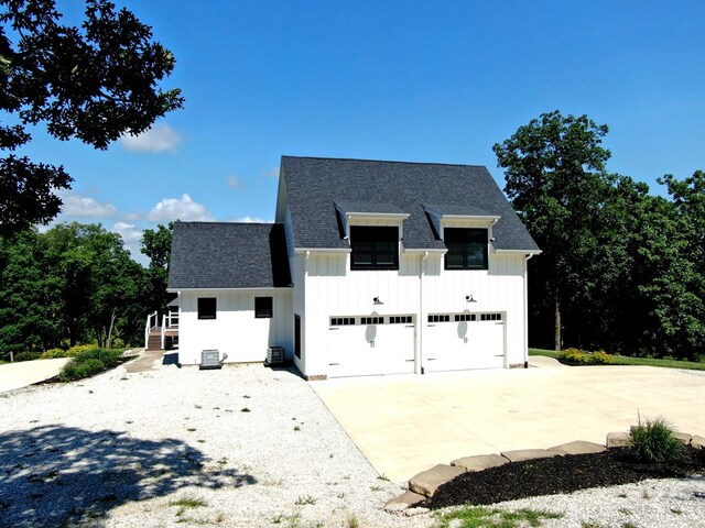 22585 State Highway K, Novinger, MO 63559 - view of front of property with board and batten siding, roof with shingles, concrete driveway, and a garage