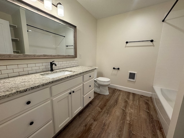 22585 State Highway K, Novinger, MO 63559 - full bathroom with wood finished floors, vanity, backsplash, heating unit, and shower / bath combination