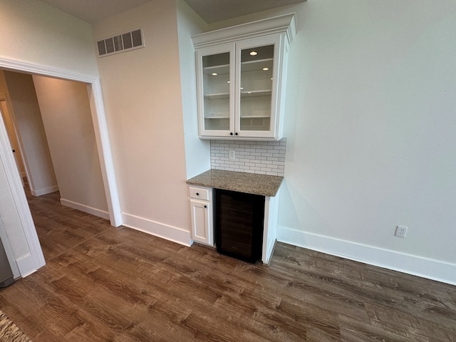 22585 State Highway K, Novinger, MO 63559 - indoor dry bar with beverage cooler, dark wood finished floors, and decorative backsplash