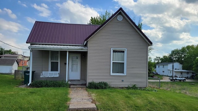 507 W Illinois St, Kirksville, MO 63501 - view of front facade featuring a front lawn, metal roof, and covered porch