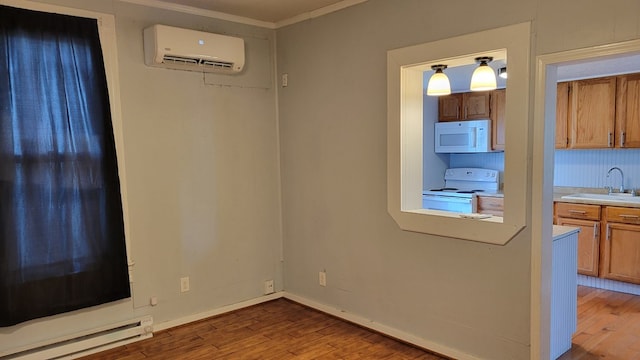 507 W Illinois St, Kirksville, MO 63501 - unfurnished dining area with a baseboard heating unit, an AC wall unit, a sink, wood finished floors, and crown molding