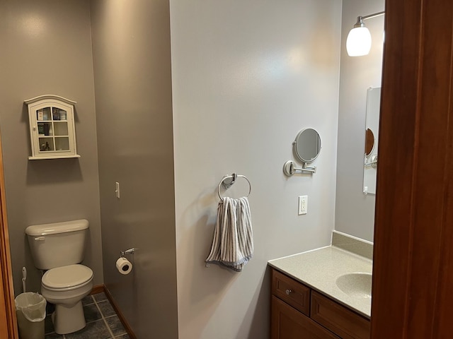 bathroom with vanity, toilet, and tile patterned floors