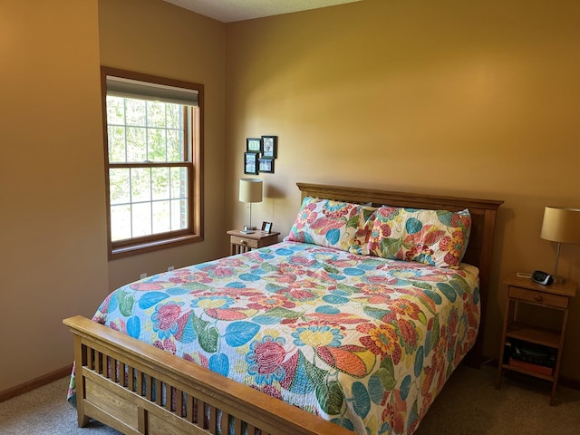 carpeted bedroom featuring baseboards