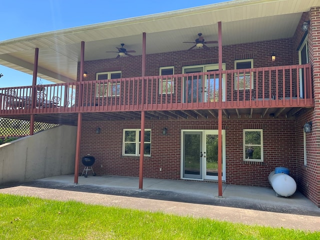 rear view of property featuring brick siding and ceiling fan