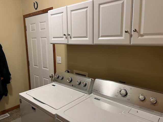 laundry room with separate washer and dryer, cabinet space, visible vents, and baseboards