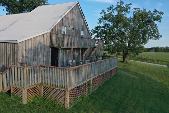 view of home's exterior with a yard and a deck