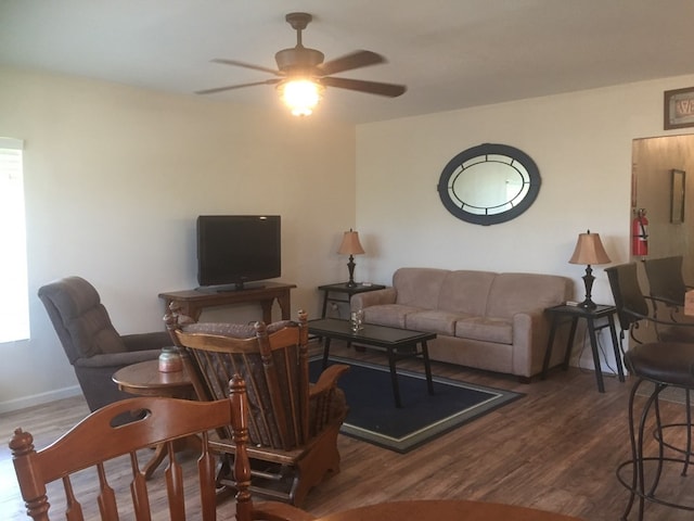 living room featuring dark hardwood / wood-style floors and ceiling fan