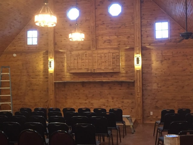 interior space featuring vaulted ceiling and wood walls