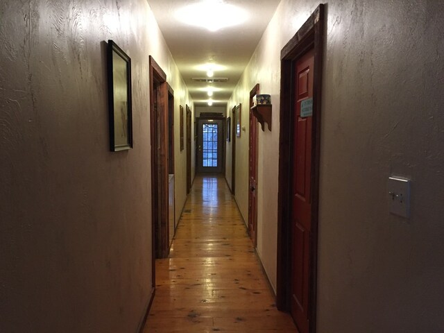 hall with wood-type flooring