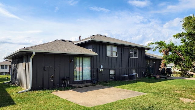 rear view of property with central AC, a patio area, and a lawn