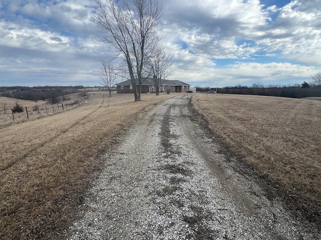 view of road with driveway and a rural view