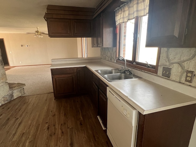 kitchen featuring dishwasher, dark wood-style flooring, a sink, light countertops, and backsplash