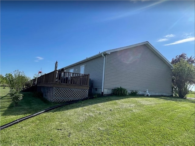 view of property exterior featuring a lawn and a wooden deck