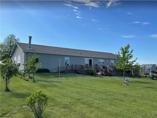 back of property featuring a deck and a yard