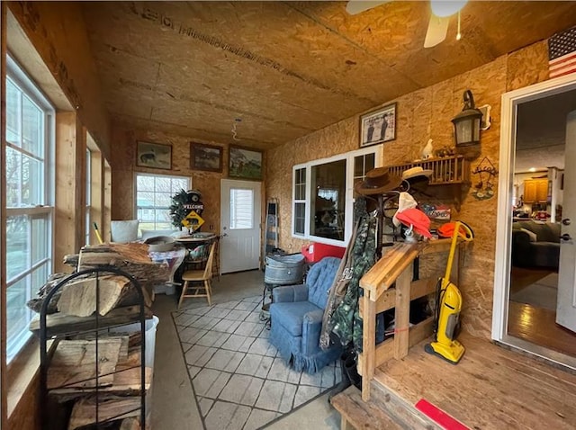 sunroom / solarium featuring a ceiling fan