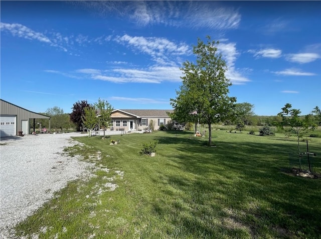 view of yard featuring a garage and driveway