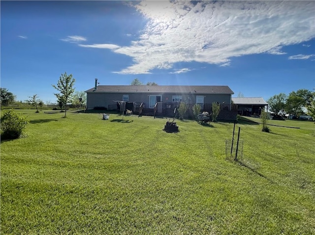 view of front of property with a wooden deck and a front yard