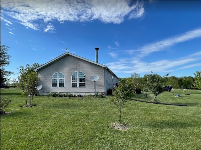 view of home's exterior with a lawn