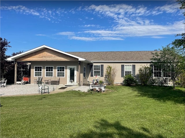 back of property with a patio area and a yard