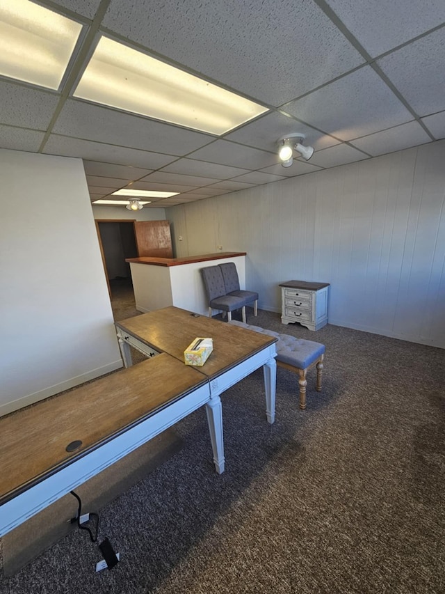 exercise area with carpet floors and a paneled ceiling