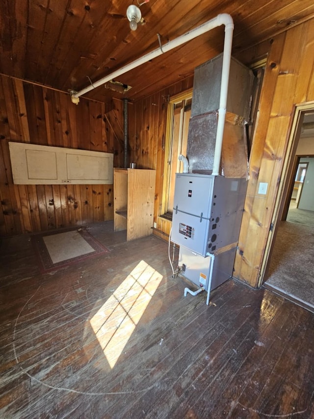 below grade area with wooden ceiling, dark wood finished floors, and wooden walls