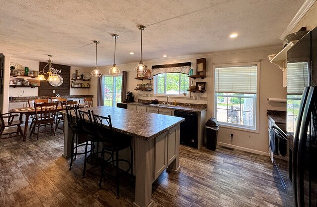 210 N Grant St, Green City, MO 63545 - kitchen featuring open shelves, black appliances, a textured ceiling, dark countertops, and a sink