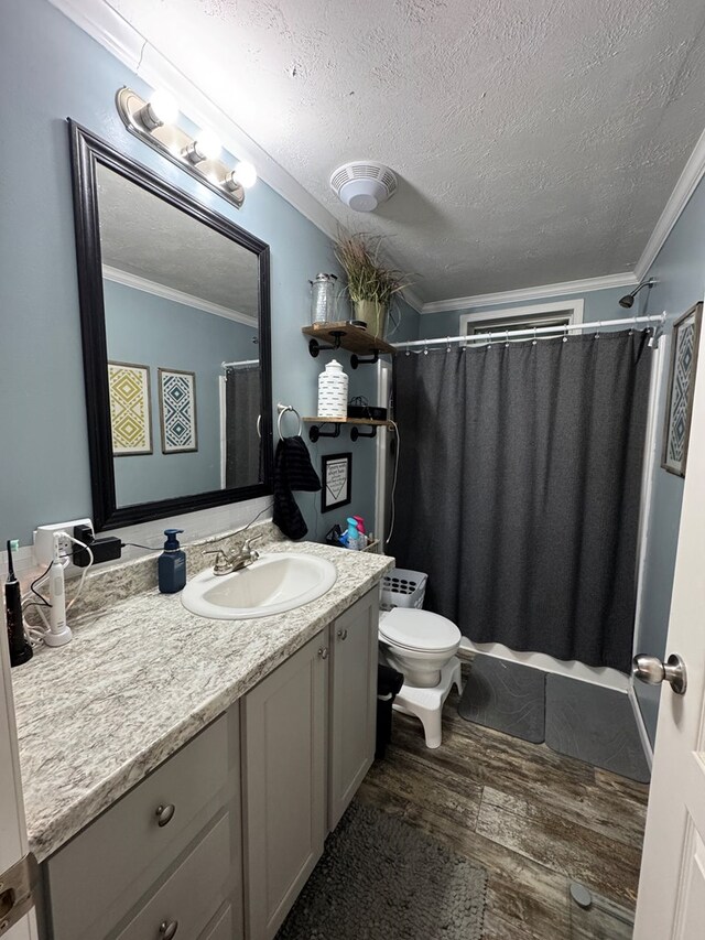 210 N Grant St, Green City, MO 63545 - bathroom with a textured ceiling, wood finished floors, vanity, toilet, and ornamental molding