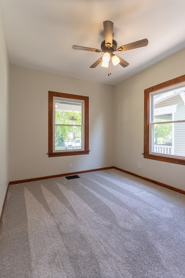 516 Barrow St, Moberly, MO 65270 - carpeted empty room featuring plenty of natural light, baseboards, and a ceiling fan
