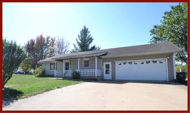 ranch-style home featuring a garage, covered porch, and a front lawn