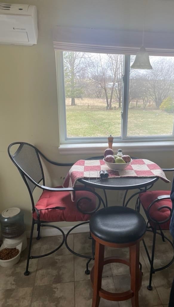 411 W W, Callao, MO 63534 - dining space featuring a wall mounted air conditioner and tile patterned flooring